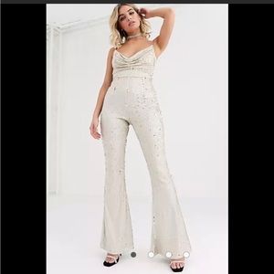 Rare London cowl front sequin jumpsuit with chain strap detail in light gold.